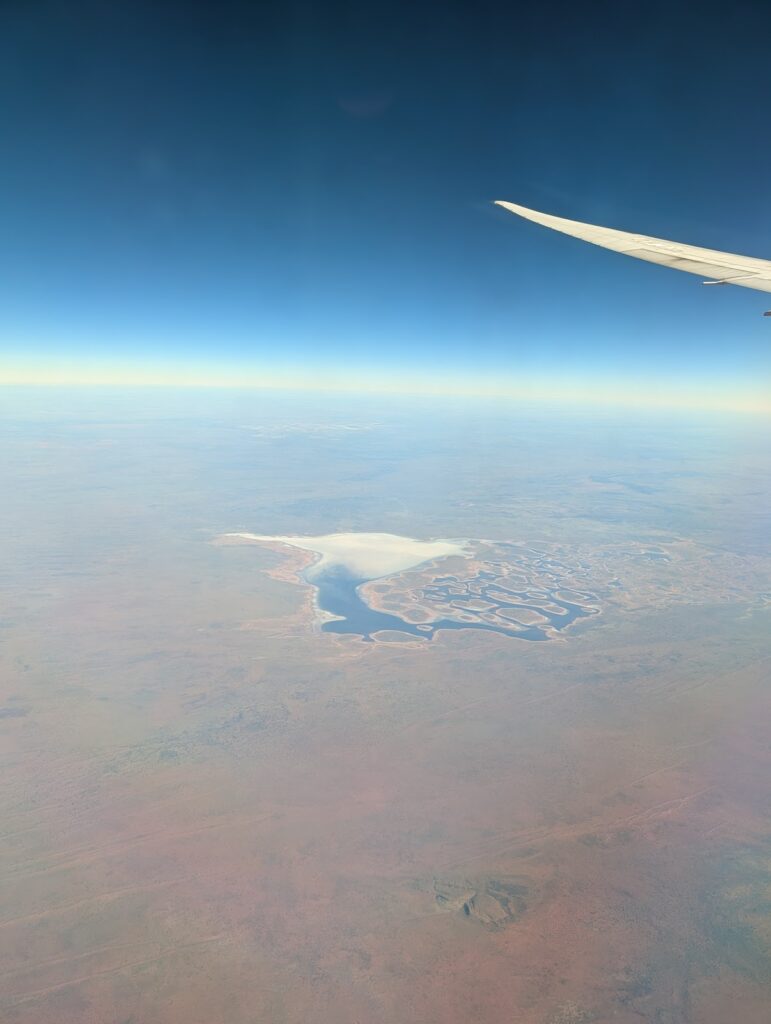 Central Australia after recent rain — the salt pans filled. You don't get this view from the middle of the plane.
