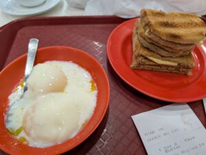Traditional Singapore Kaya Toast with coddled eggs and sweet tea.