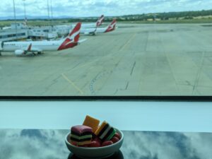 bowl of licorice allsorts at the Qantas Club lounge, Melbourne Airport, with Qantas aircraft on the tarmac