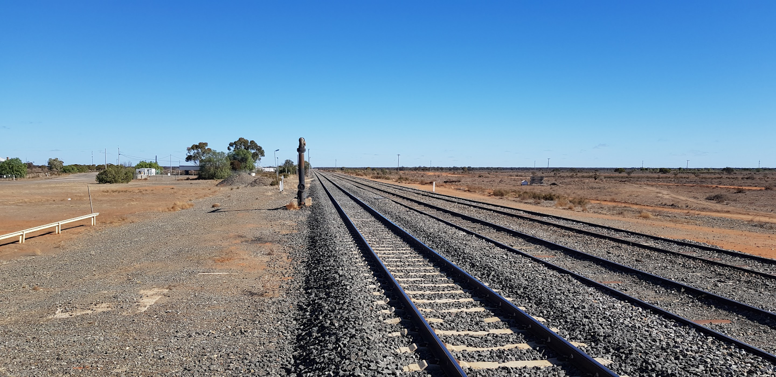 Railway track stretching to the horizon across the outback on the NSW Broken Hill line