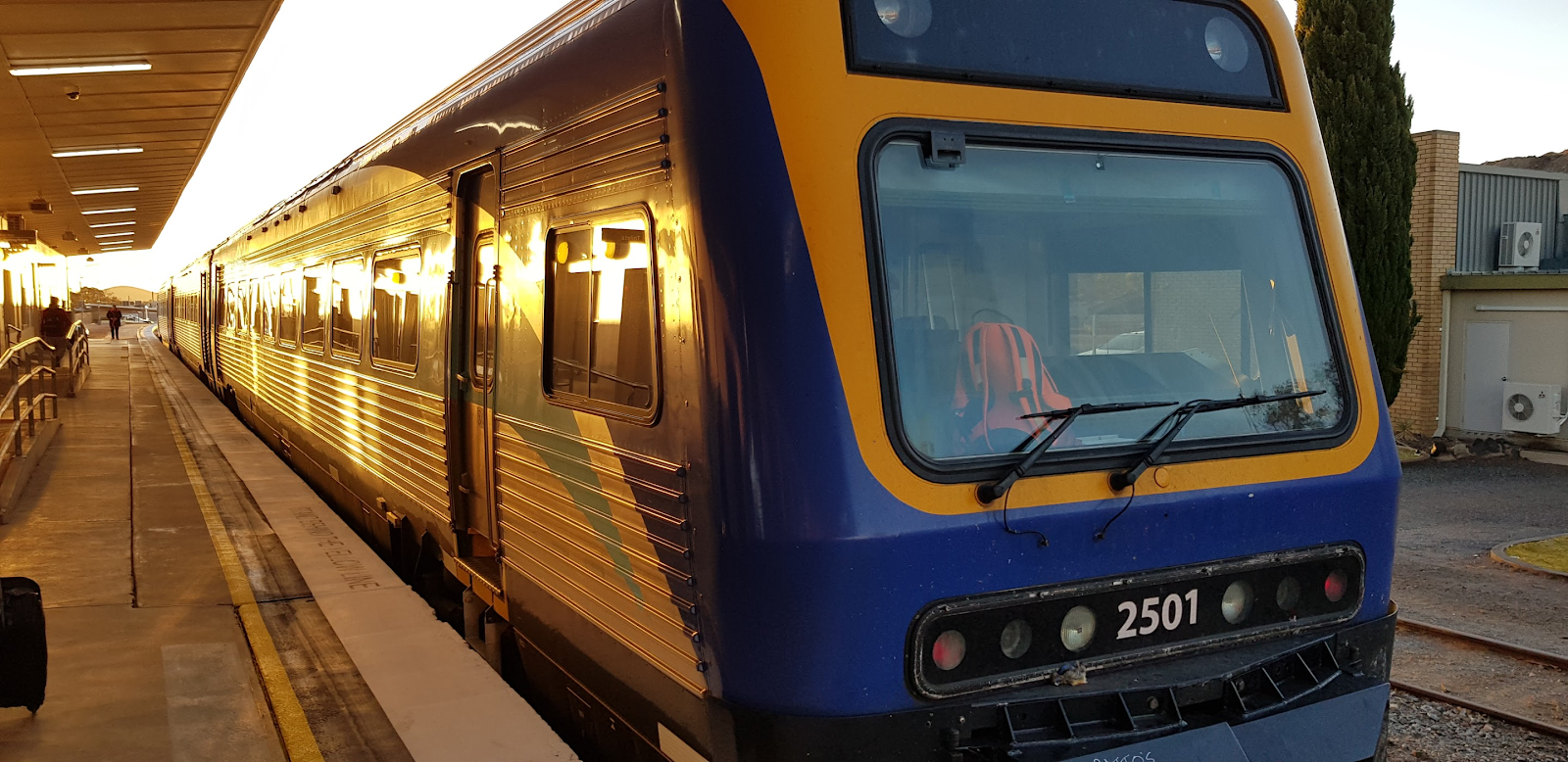 NSW TrainLink Outback Xplorer railcar at Broken Hill station platform at sunset