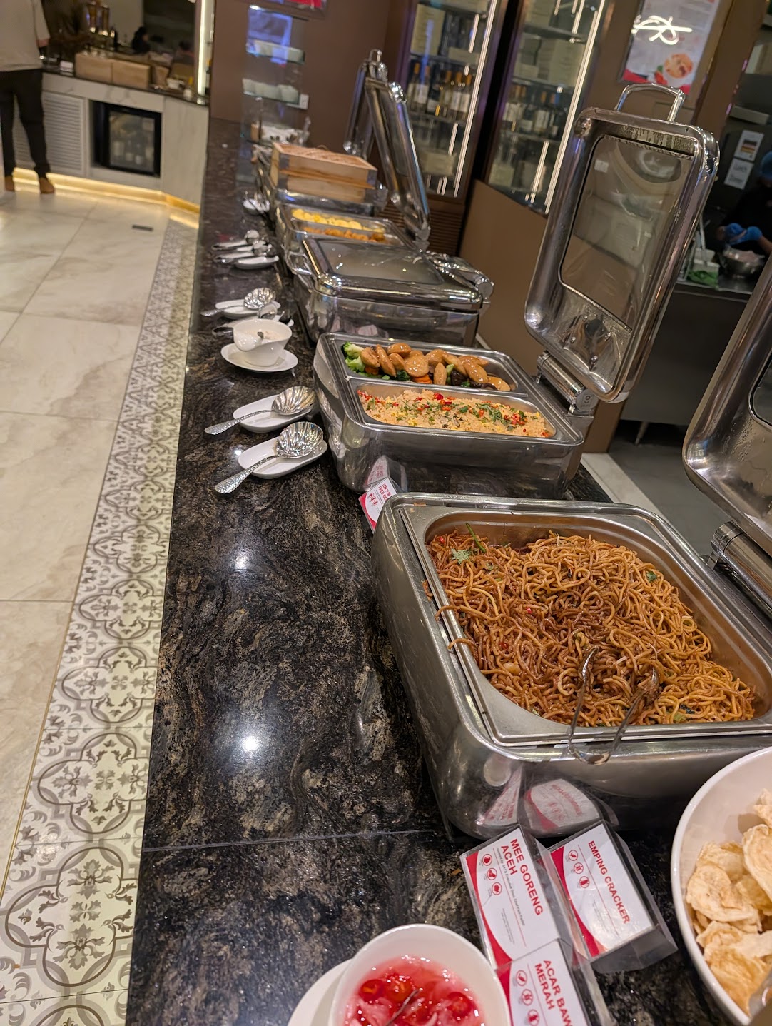 Hot buffet line at SATS Premier Lounge Changi with mee goreng noodles, fried rice and chafing dishes