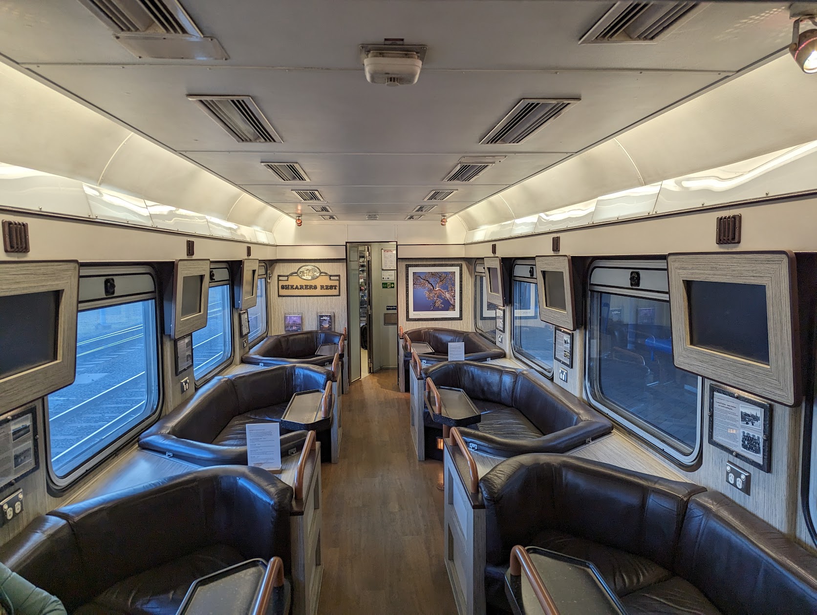 The Shearers Rest lounge carriage on the Spirit of the Outback, with leather tub chairs and timber panelling