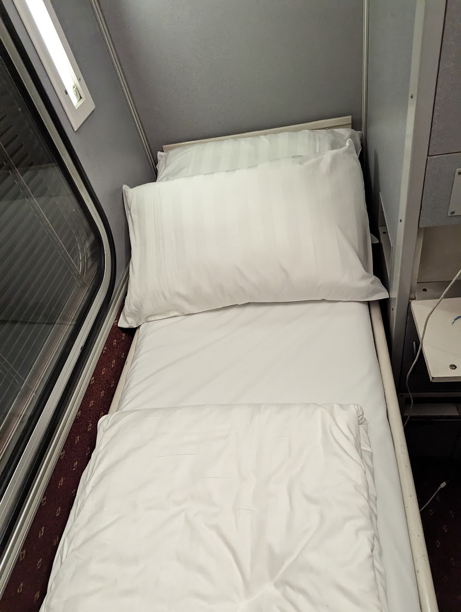 First class sleeper cabin made up as a bed on the Spirit of the Outback train, Brisbane to Longreach