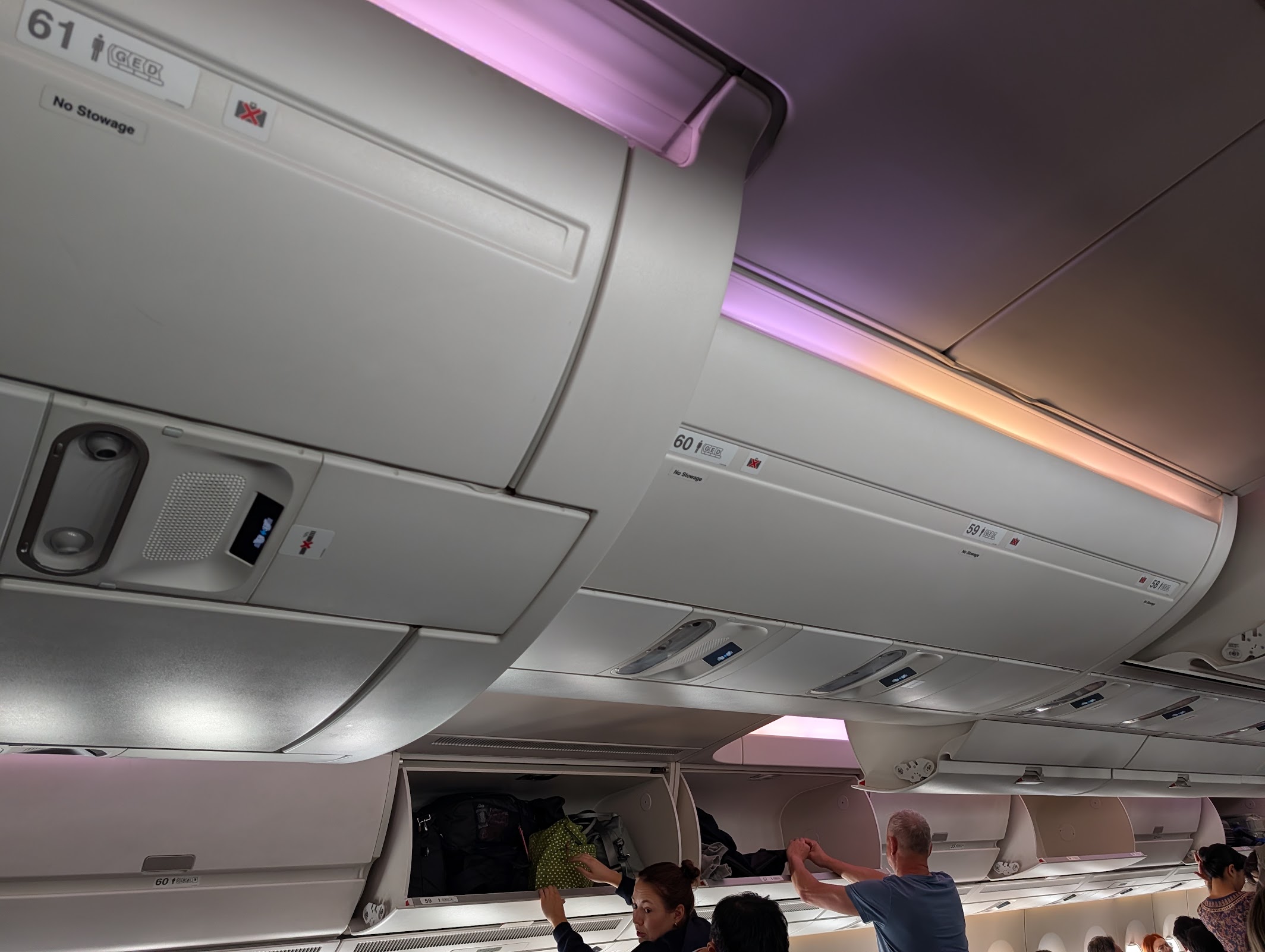 Singapore Airlines A350-900 overhead bins at row 61 showing No Stowage signs, economy cabin