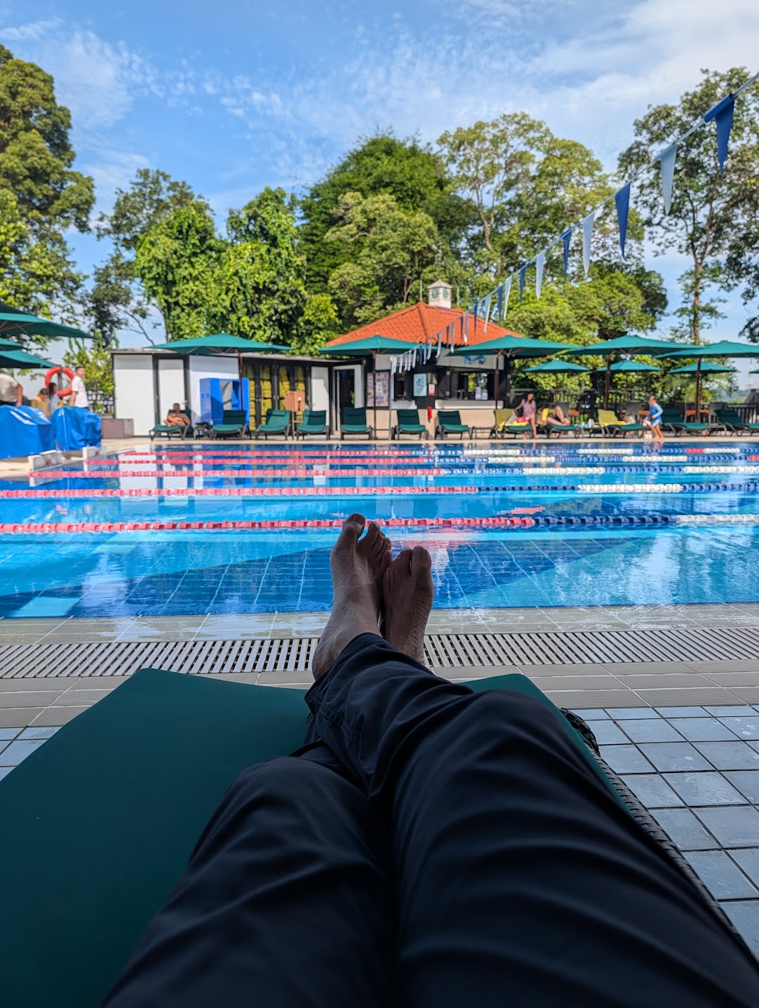 The British Club pool and clubhouse, Singapore, seen from a poolside lounger