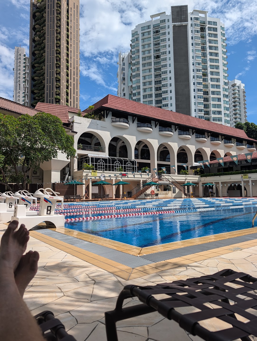 Poolside at the Tanglin Club, Singapore — 50-metre lap pool and loungers seen from a sun lounger