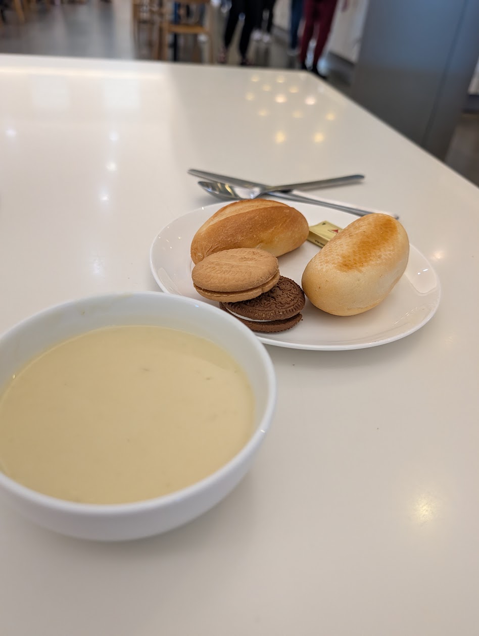 Bowl of soup with bread rolls and biscuits at the Qantas Club Brisbane self-serve station