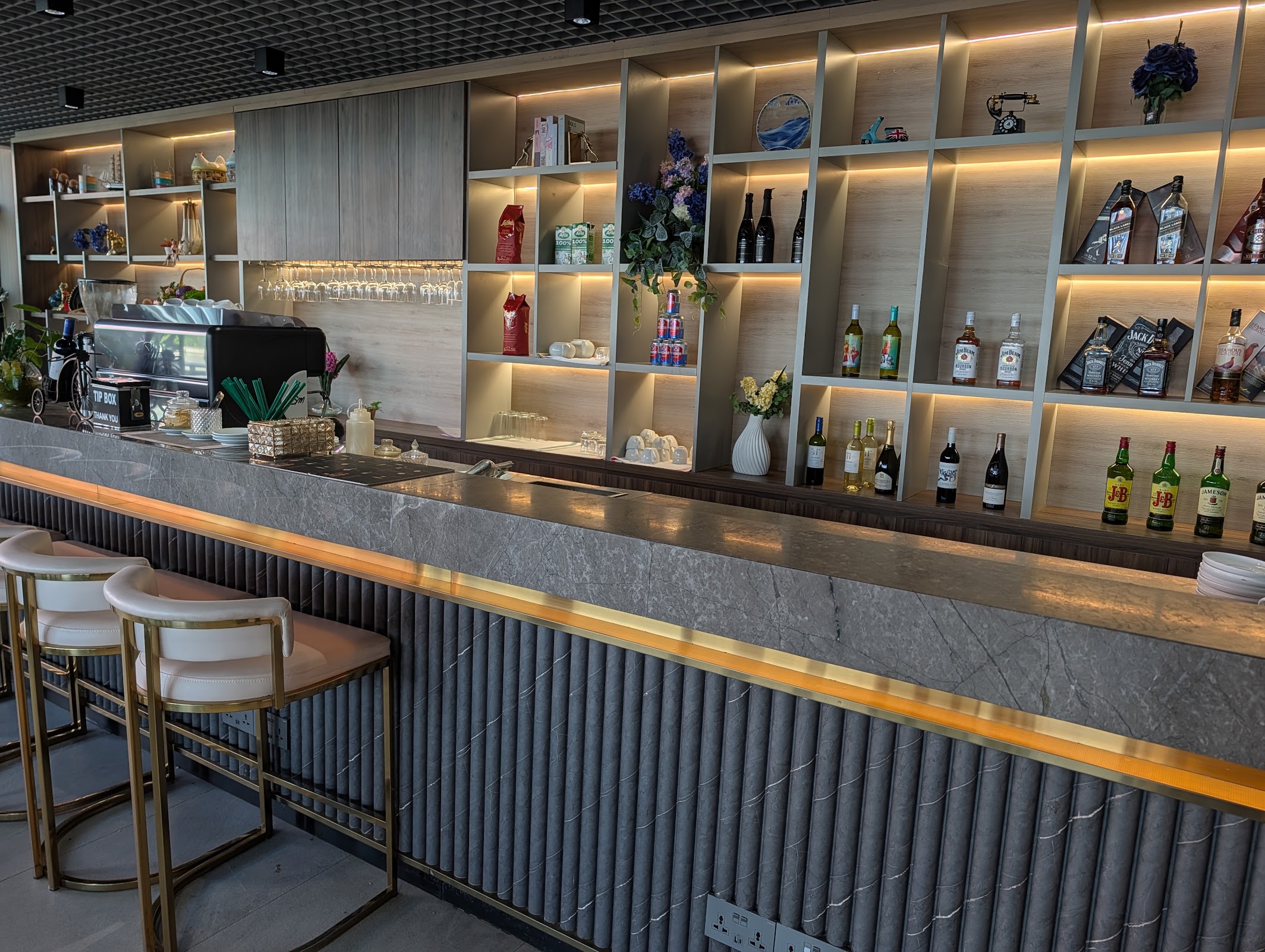 Bar and barista coffee station with wine and whisky shelves at the Angkor Lounge