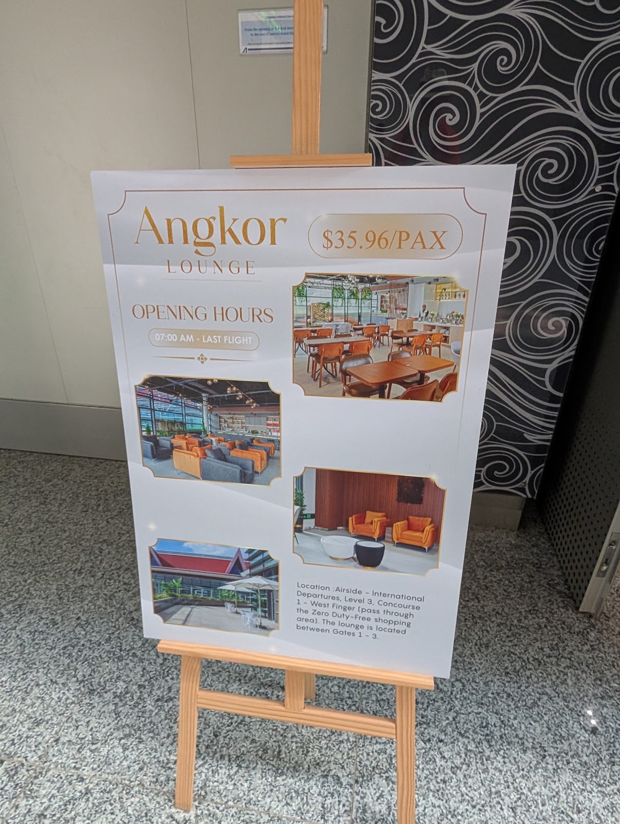 Angkor Lounge sign showing opening hours 7am to last flight and walk-in price of USD 35.96