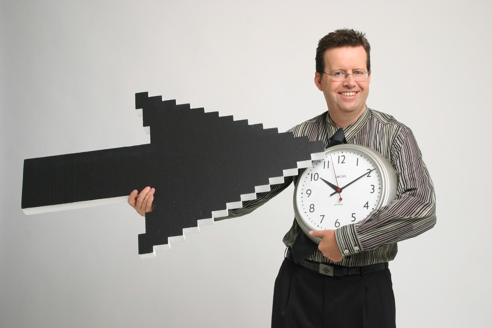Drew holding a giant cursor and a clock in CommBank's NetBank photo shoot, early 2000s