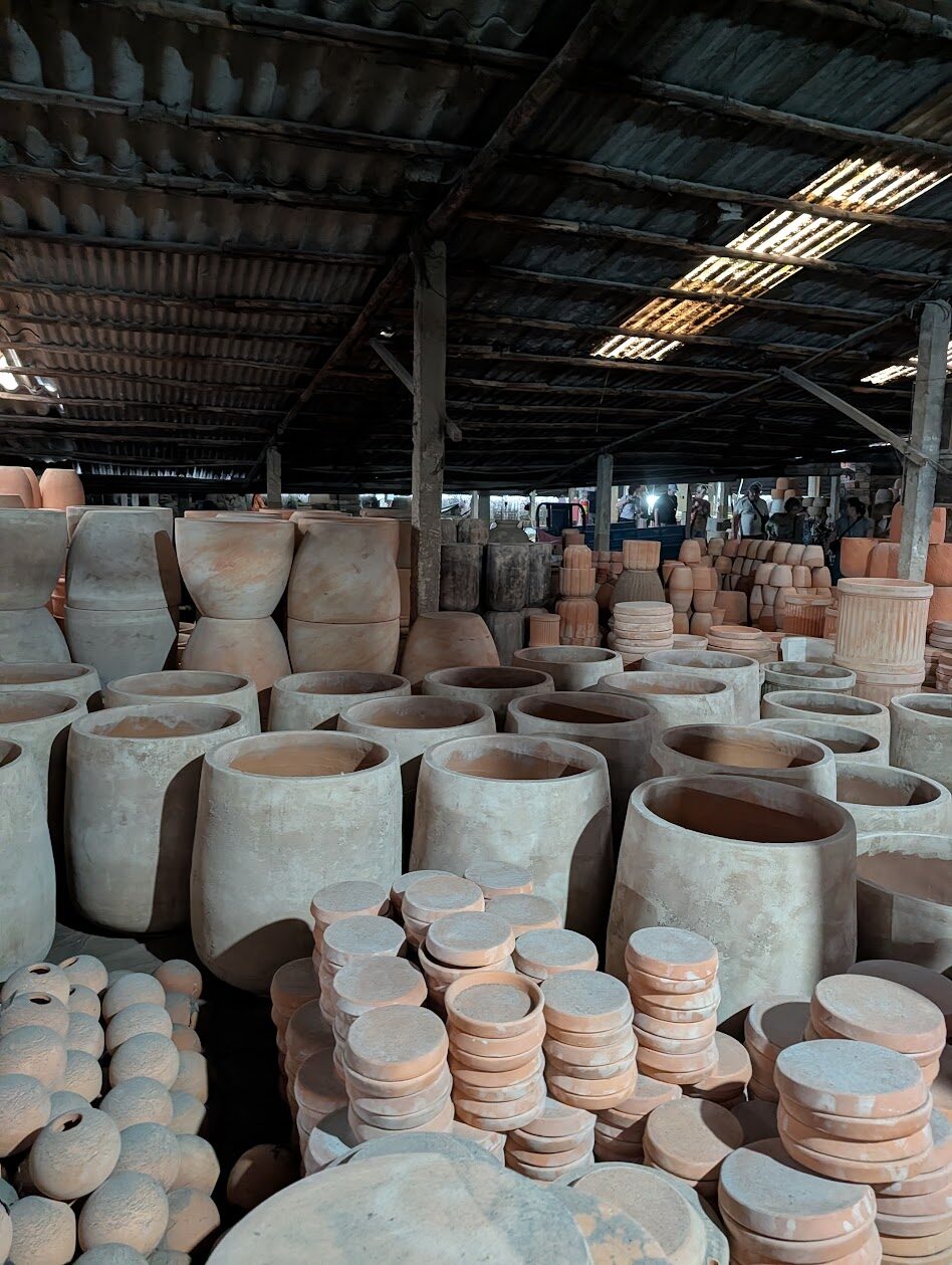 Terracotta pots stacked in a Mang Thit pottery workshop in the Mekong Delta